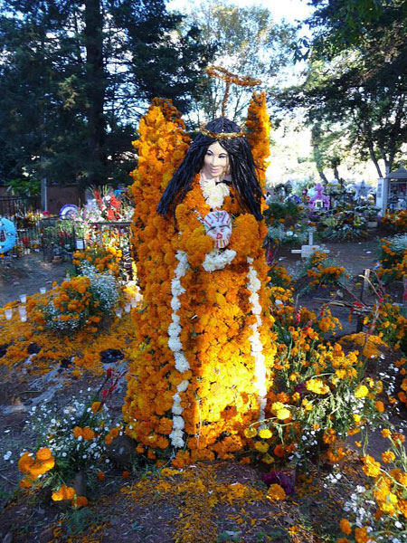 Angel made of marigolds amogst the ofrendas. Patzcuaro, Michoacan