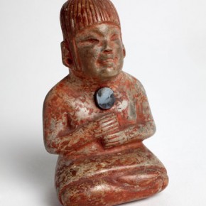 Seated female figure with polished hematite disk