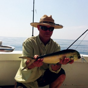 The Author with a fly caught Dorado. Caught under a log 18 miles out.